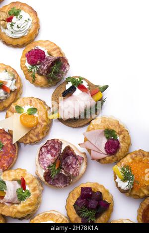 A top view of canapes with different ingredients on a white background Stock Photo