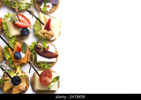 A top view of canapes with different ingredients on a white background Stock Photo