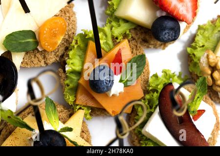 A top view of canapes with different ingredients on a white background Stock Photo