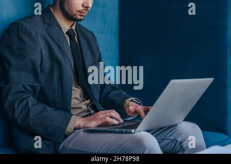 Businessman works in cubicle at corporate business. Stock Photo