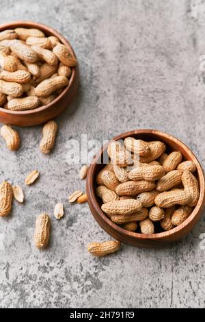 Image of bunch of peanuts in a bowl on a concrete surface Stock Photo