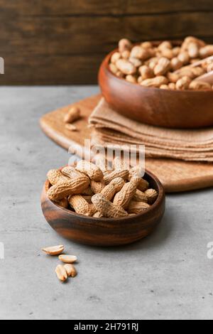 Image of bunch of peanuts in a bowl on a concrete surface Stock Photo