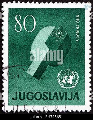 YUGOSLAVIA - CIRCA 1960: a stamp printed in the Yugoslavia shows Atom and UN Emblem, 15th Anniversary of UN, circa 1960 Stock Photo