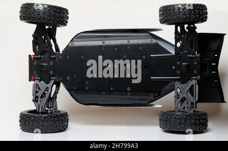Bottom of rc buggy car with metal black suspension isolated on studio background Stock Photo