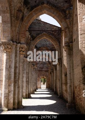 Chiusdino, Italy - August 14 2021: Abbazia San Galgano Abbey, the Ruin of a Gothic Monastery Interior Side Aisle Stock Photo