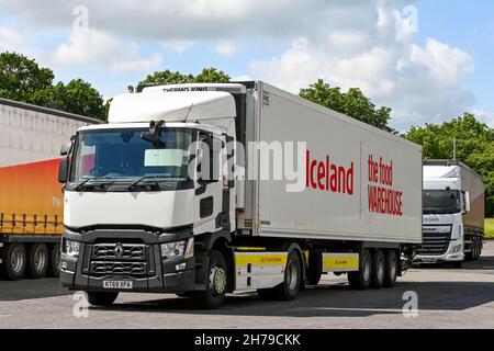 Swindon, England - June 2021: Refrigerated articulated lorry operated by the Iceland frozen food company parked in a motorway service station Stock Photo
