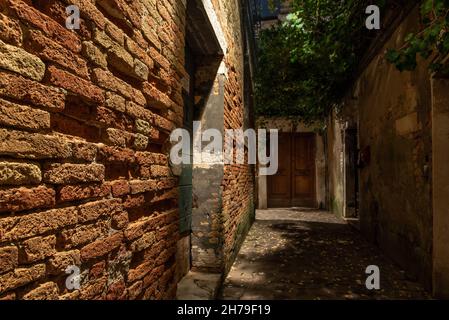 Old Brickwall in a narrow Alley in Cannaregio District, Venice, Italy Stock Photo