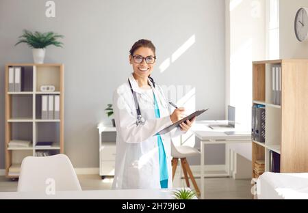 Portrait of smiling female doctor in white uniform Stock Photo