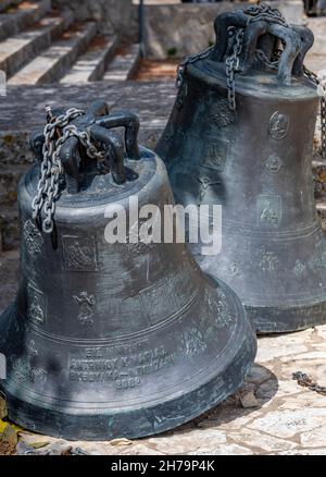 large antique brass bells at an orthodox church on the greek island of zante or zakynthos, antique church bells no longer in use. Stock Photo