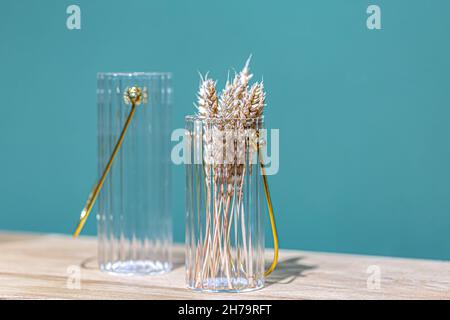 Decorative glass jars for storage on a blue background. Stock Photo
