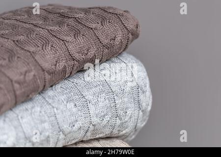 Close-up of textured knitted blankets in a stack. Stock Photo