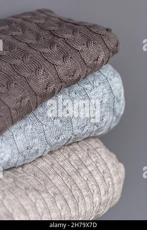 Close-up of textured knitted blankets in a stack. Stock Photo
