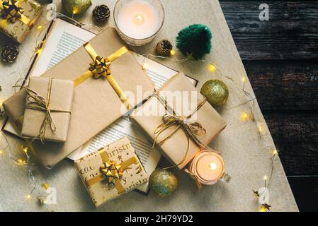 Merry Christmas. Top view of books, Christmas gifts and Christmas decorations on wooden table. Christmas concept background. Selective focus Stock Photo