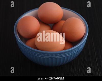 Brown hard boiled eggs in a bowl. Close up. Stock Photo