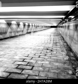 Beautiful art photo underground pedestrian crossing in the city illuminated by artificial light. Stock Photo