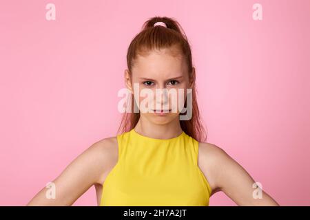 upset unsatisfied teen girl on pink background. Stock Photo