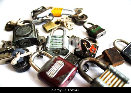 A pile of different metal padlocks on a white background Stock Photo