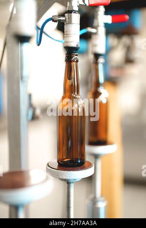 Empty bottles prepared for beer filling. Stock Photo