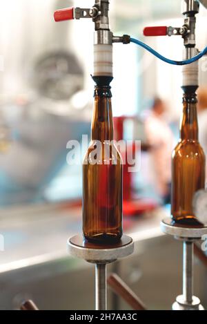 Empty bottles prepared for beer filling. Stock Photo