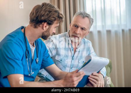 Sad patient having a conversation with a physician Stock Photo