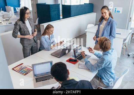 Team of business professionals having a discussion during a briefing Stock Photo