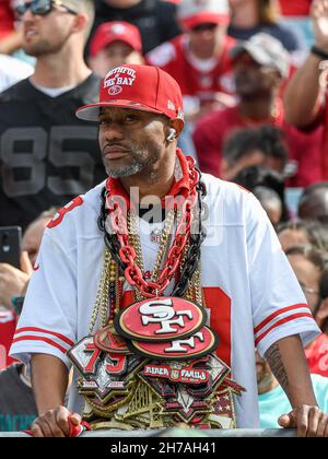 A San Francisco 49ers fan sports a Super Bowl ring hat and holds a