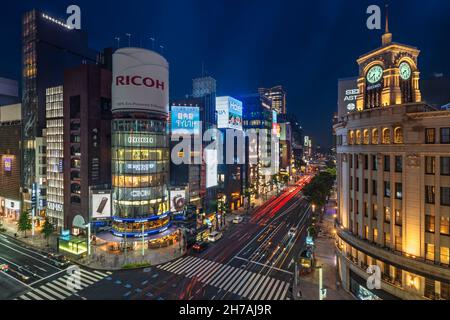 tokyo, japan - july 05 2021: Night upper view of the clock tower of the Ginza Wako building illuminated and the tower of sanai dream center at the jun Stock Photo