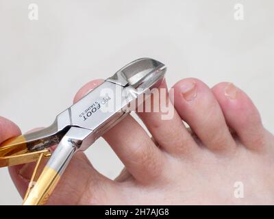 Toenail clippers in use. Stock Photo