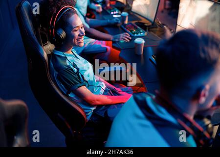Professional woman gamer participates in team play in cyber club Stock Photo