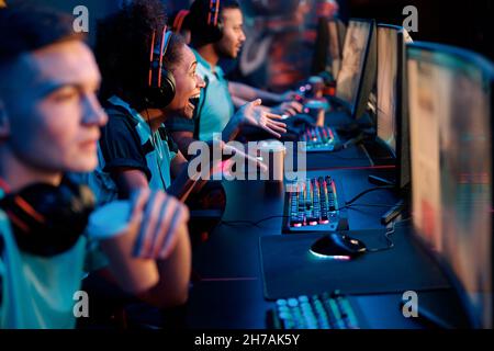 Esports team playing game on computers in gaming club Stock Photo