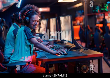 Esports team playing game on computers in gaming club Stock Photo