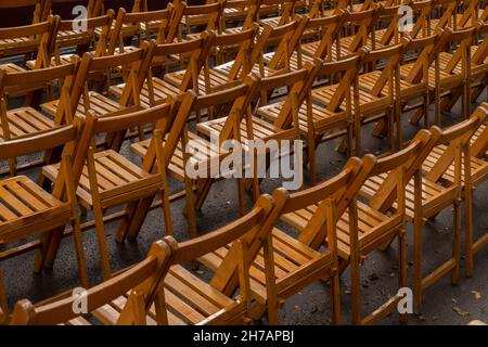 Set of empty folding chairs lined up before an event. Stock Photo