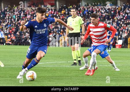 Granada, Spain. 21st Nov, 2021. Marco Asensio of Real Madrid being followed by Carlos Neva of Granada CF during La Liga Santander match between Granada CF and Real Madrid CF at Los Carmenes Stadium in Granada (Credit Image: © Jose M. Baldomero/Pacific Press via ZUMA Press Wire) Credit: ZUMA Press, Inc./Alamy Live News Stock Photo