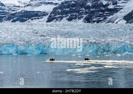 Zodiacs at the front face of the Bredegletcher, Vikingebugt Inlet, Scoresby Sund, Greenland Stock Photo