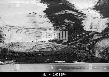 Glacial scree and crevasses, Bredegletcher, Vikingebugt Inlet, Scoresby Sund, Greenland Stock Photo