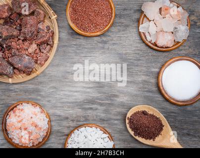 Types of salt background. Several types of salt on a wooden background Stock Photo