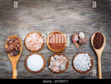 A variety of types of salt on a wooden surface Stock Photo