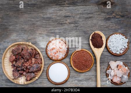 Several types of salt in bowls on the wooden background Stock Photo