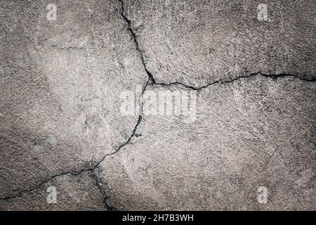 gray concrete background. cracks in the old asphalt on the road Stock Photo