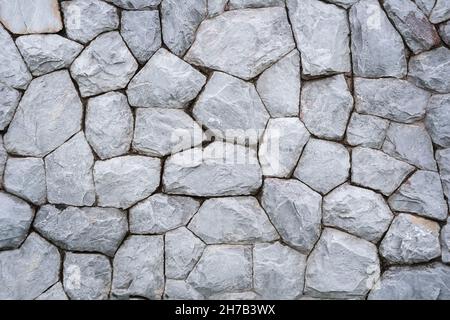 Stone wall background. Texture wall from gray round stones Stock Photo
