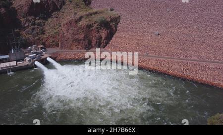 aerial ascending shot of lake argyle dam wall and water outlet Stock Photo