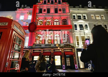 London, UK. Cartier's red illuminated, musical Christmas display in Old Bond Street. Stock Photo