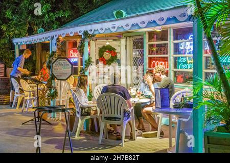 Key Largo Florida,Upper Keys,Mrs. Mac's Kitchen restaurant seafood,dining outside al fresco table,family families teen teenager night neon signs Stock Photo