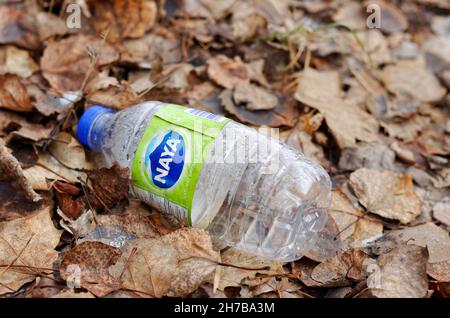 Empty plastics bottle of water laying on the ground. Quebec,Canada Stock Photo