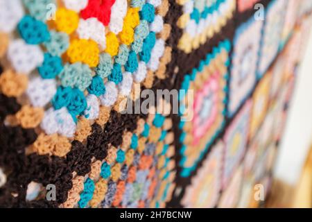 A bright Blanket with an ornament in the form of colorful squares woven from wool. The concept of fabric and national patterns Stock Photo