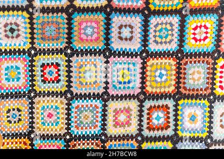A bright Blanket with an ornament in the form of colorful squares woven from wool. The concept of fabric and national patterns Stock Photo