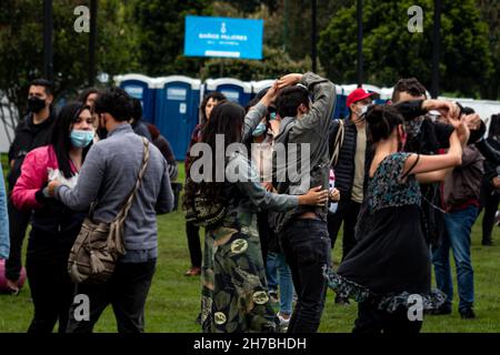 Concert goers enjoy, dance and chant to salsa cocke, salsa, cumbia and jazz during the second day of the 'IDARTES 10 AÑOS' musical festival that carries rock, metal, punk, salsa and hip hop music across two weekends (20-21 and 27-28 of November) at the Simon Bolivar Park and Scenario 'La Media Torta' in Bogota, Colombia on November 21, 2021. Stock Photo