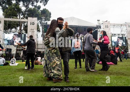 Concert goers enjoy, dance and chant to salsa cocke, salsa, cumbia and jazz during the second day of the 'IDARTES 10 AÑOS' musical festival that carries rock, metal, punk, salsa and hip hop music across two weekends (20-21 and 27-28 of November) at the Simon Bolivar Park and Scenario 'La Media Torta' in Bogota, Colombia on November 21, 2021. Stock Photo