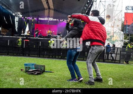 Concert goers enjoy, dance and chant to salsa cocke, salsa, cumbia and jazz during the second day of the 'IDARTES 10 AÑOS' musical festival that carries rock, metal, punk, salsa and hip hop music across two weekends (20-21 and 27-28 of November) at the Simon Bolivar Park and Scenario 'La Media Torta' in Bogota, Colombia on November 21, 2021. Stock Photo