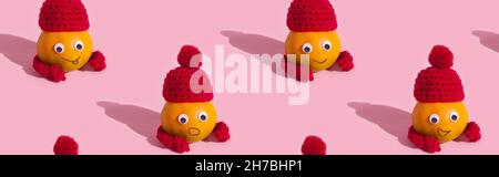 Fruit pattern of funny tangerines in hats on pink background Stock Photo